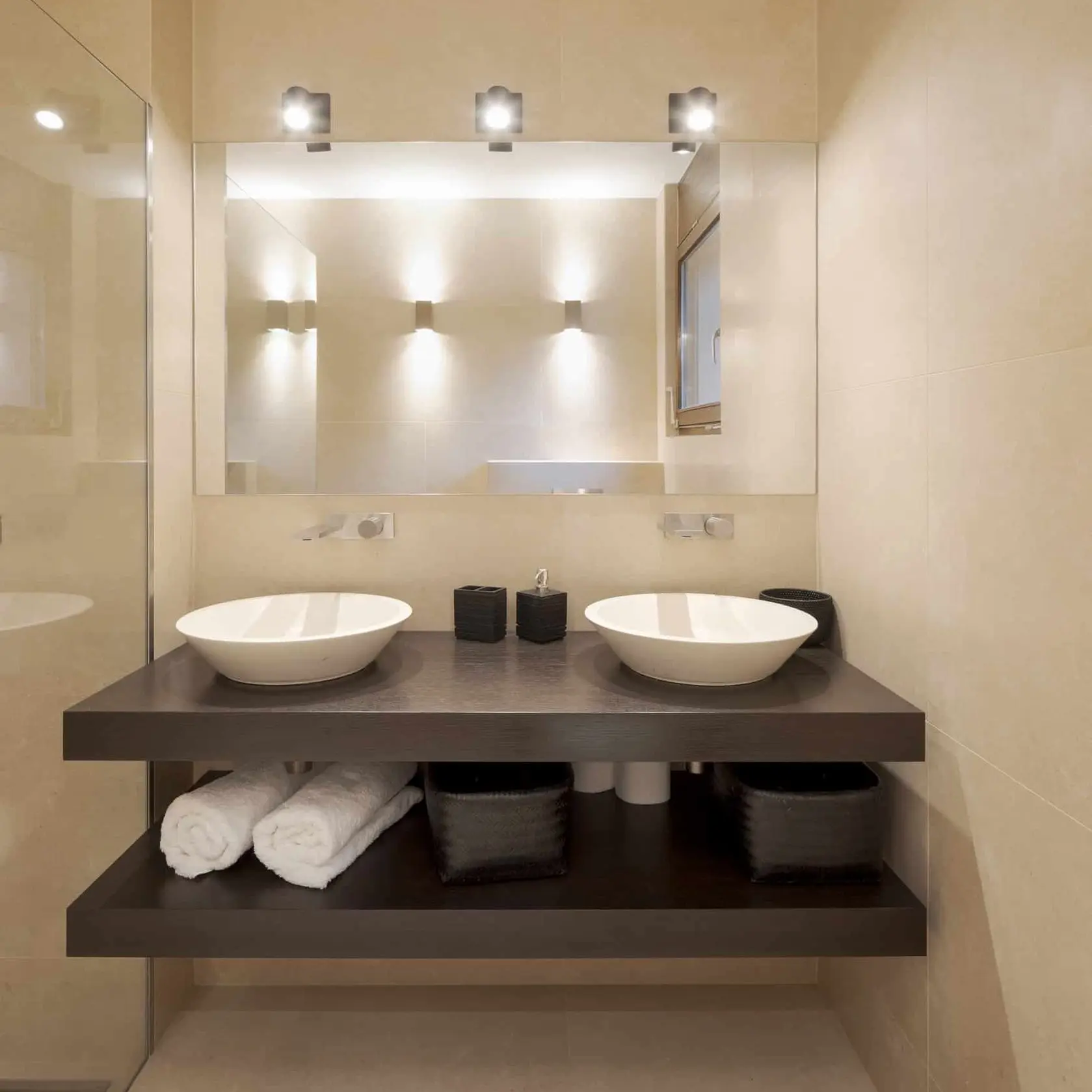 A modern bathroom with two sinks and a large mirror, providing convenience and functionality for multiple users.