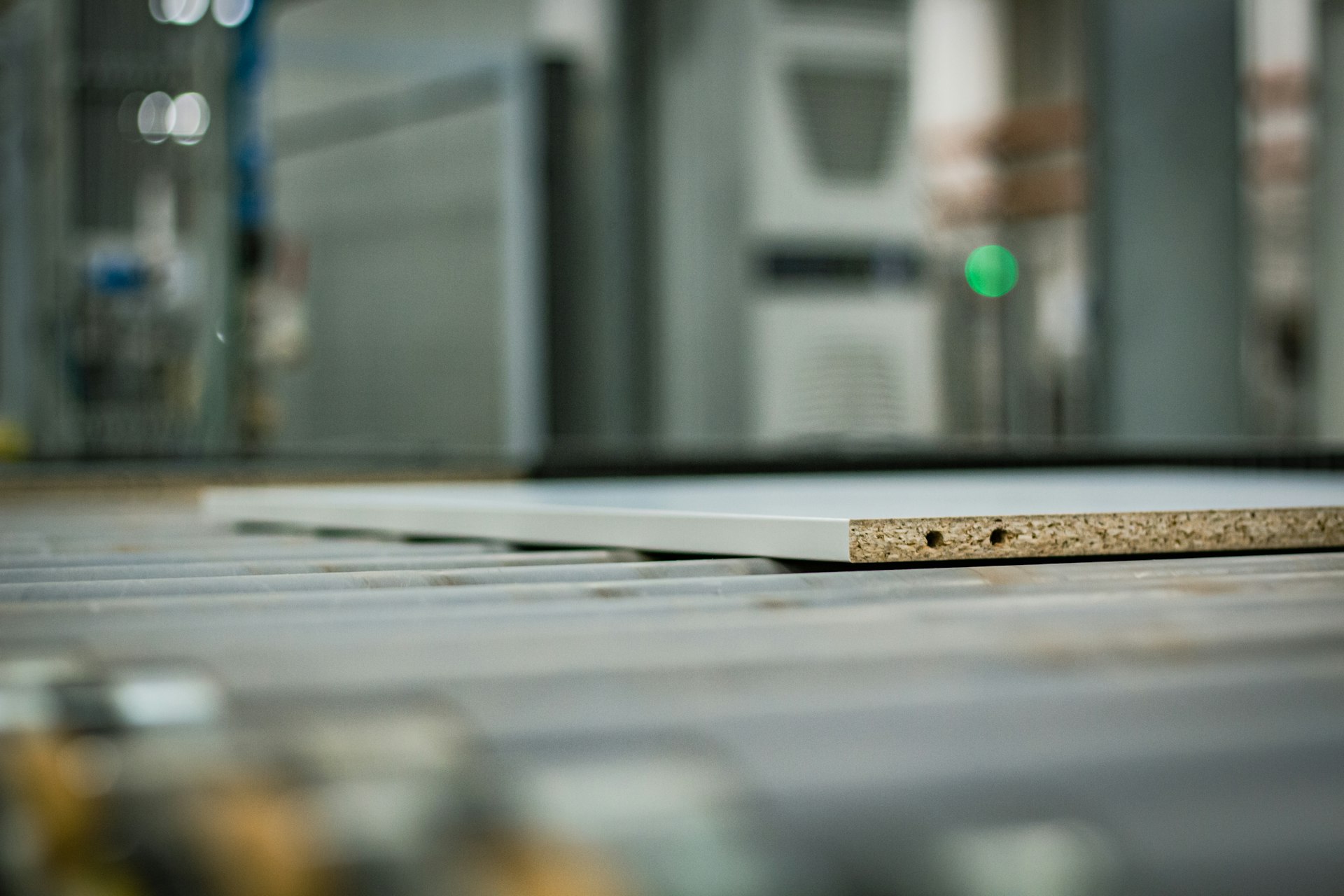 a piece of chipboard on top of a conveyor belt