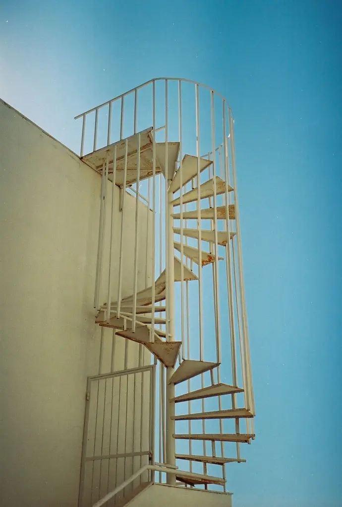 white concrete building during daytime with a staircase