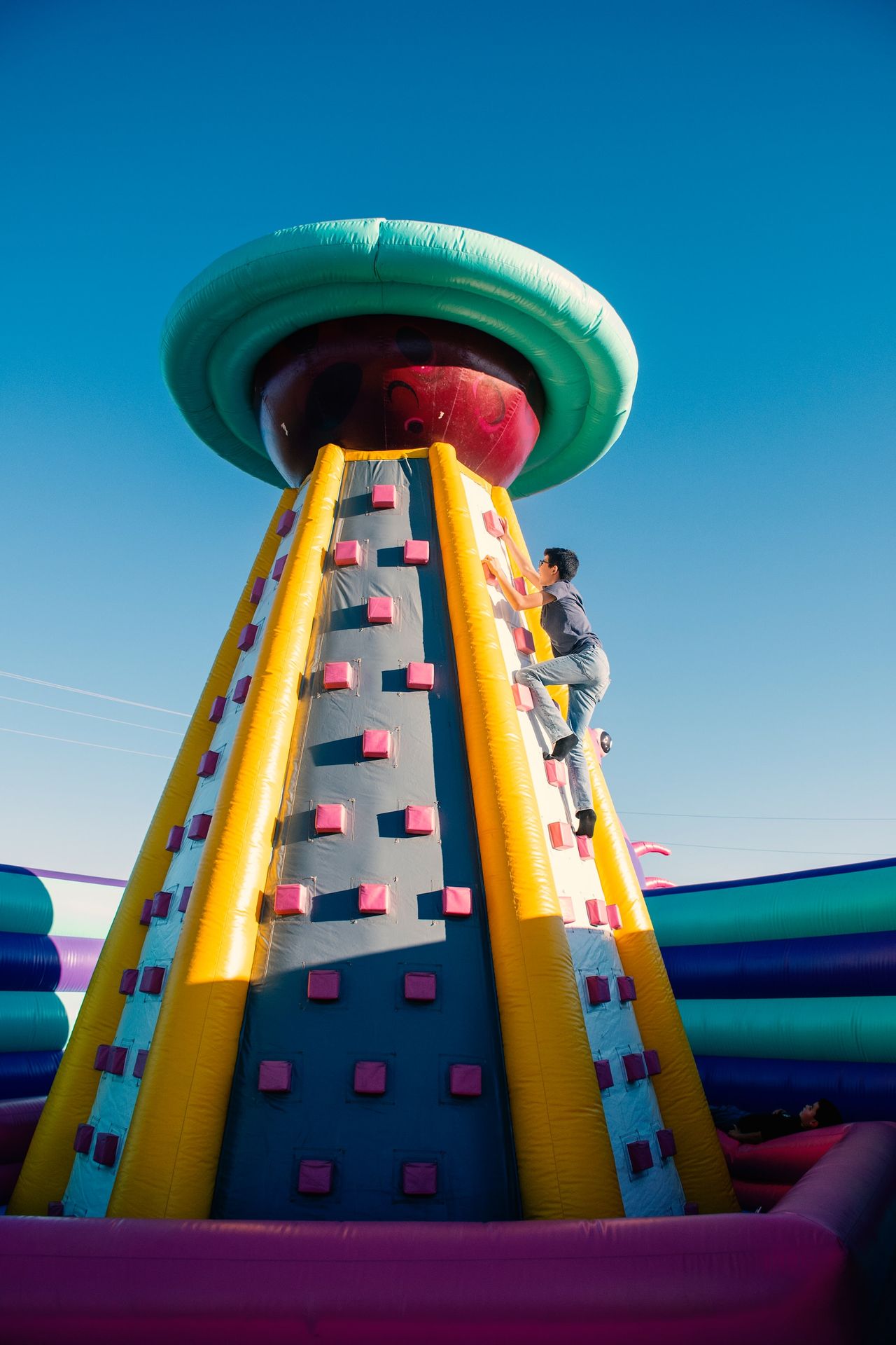 a man climbing up the side of a large inflatable structure