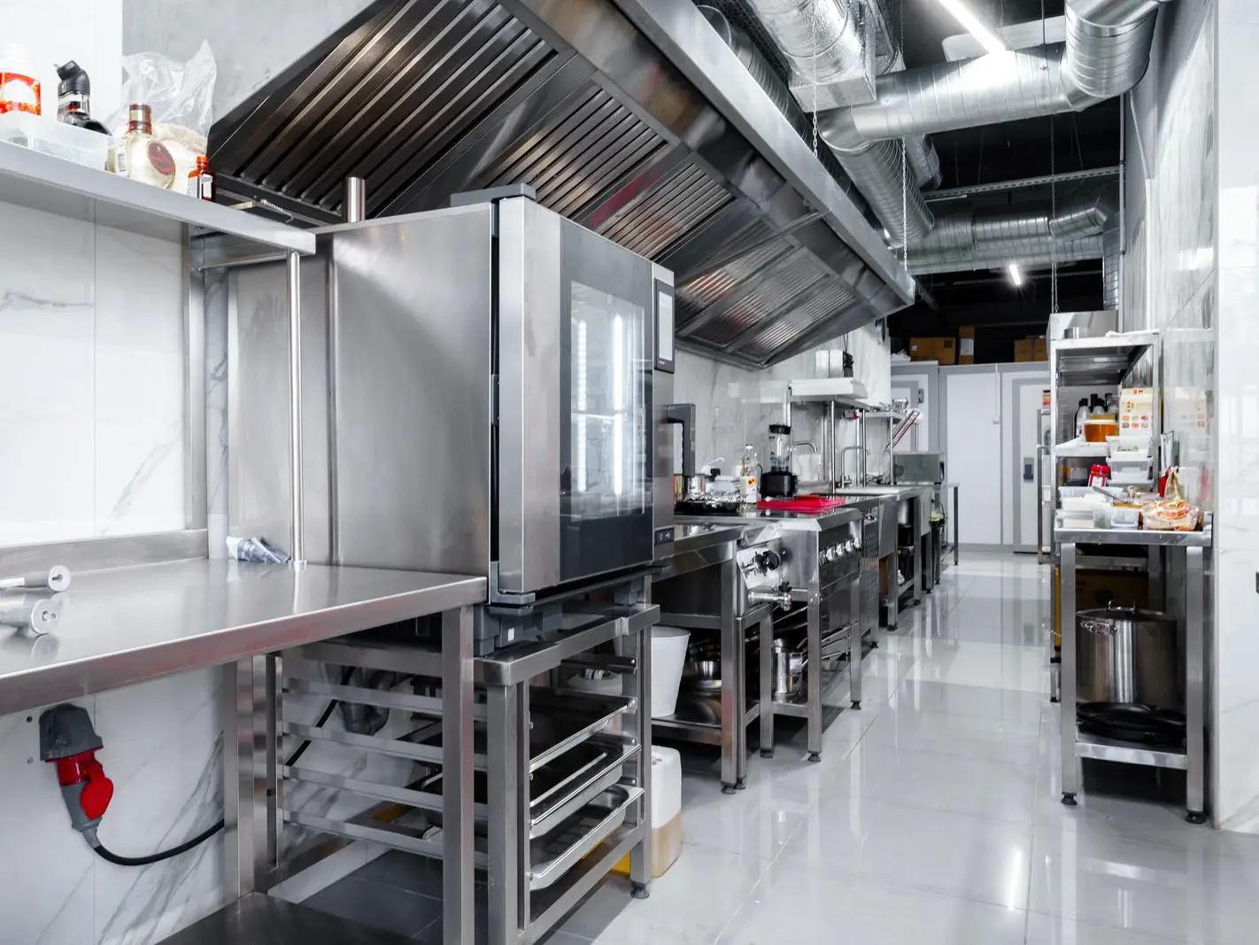 Modern commercial kitchen with sleek stainless steel appliances for efficient cooking.