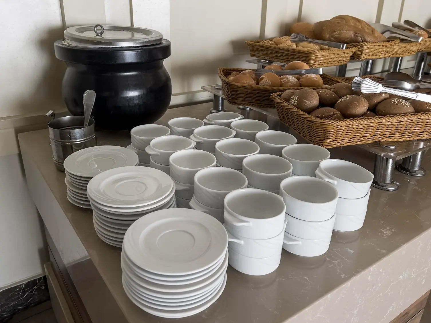 luxurious display of plates and bowls on a beautifully set buffet table.