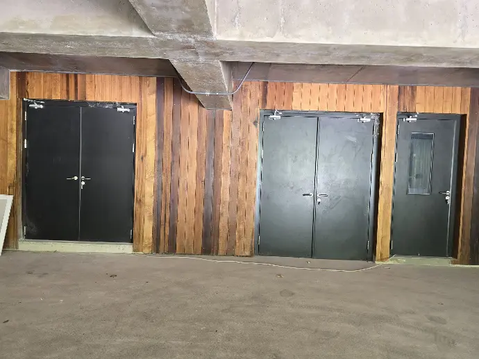 3 black steel doors next to each other