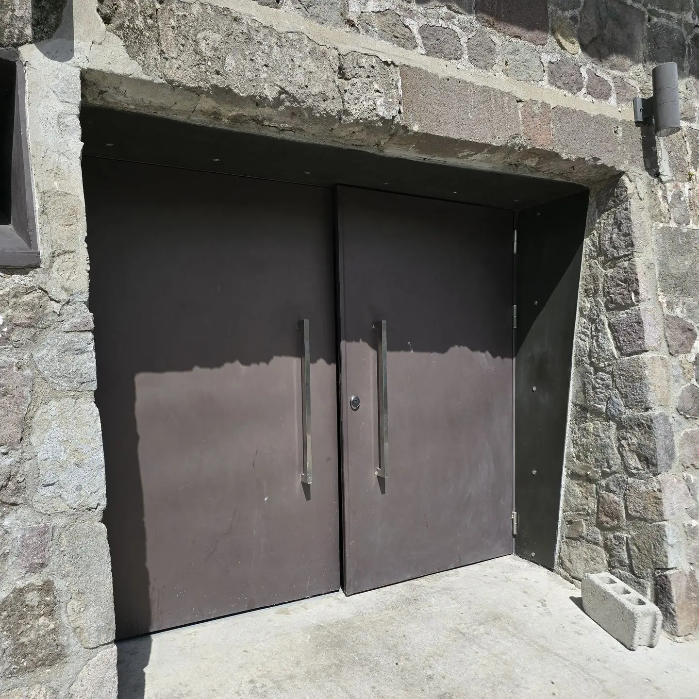 A heavy and large double swing metal door