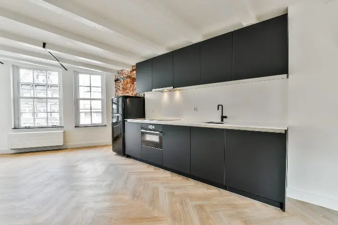 A modern kitchen featuring sleek black cabinets