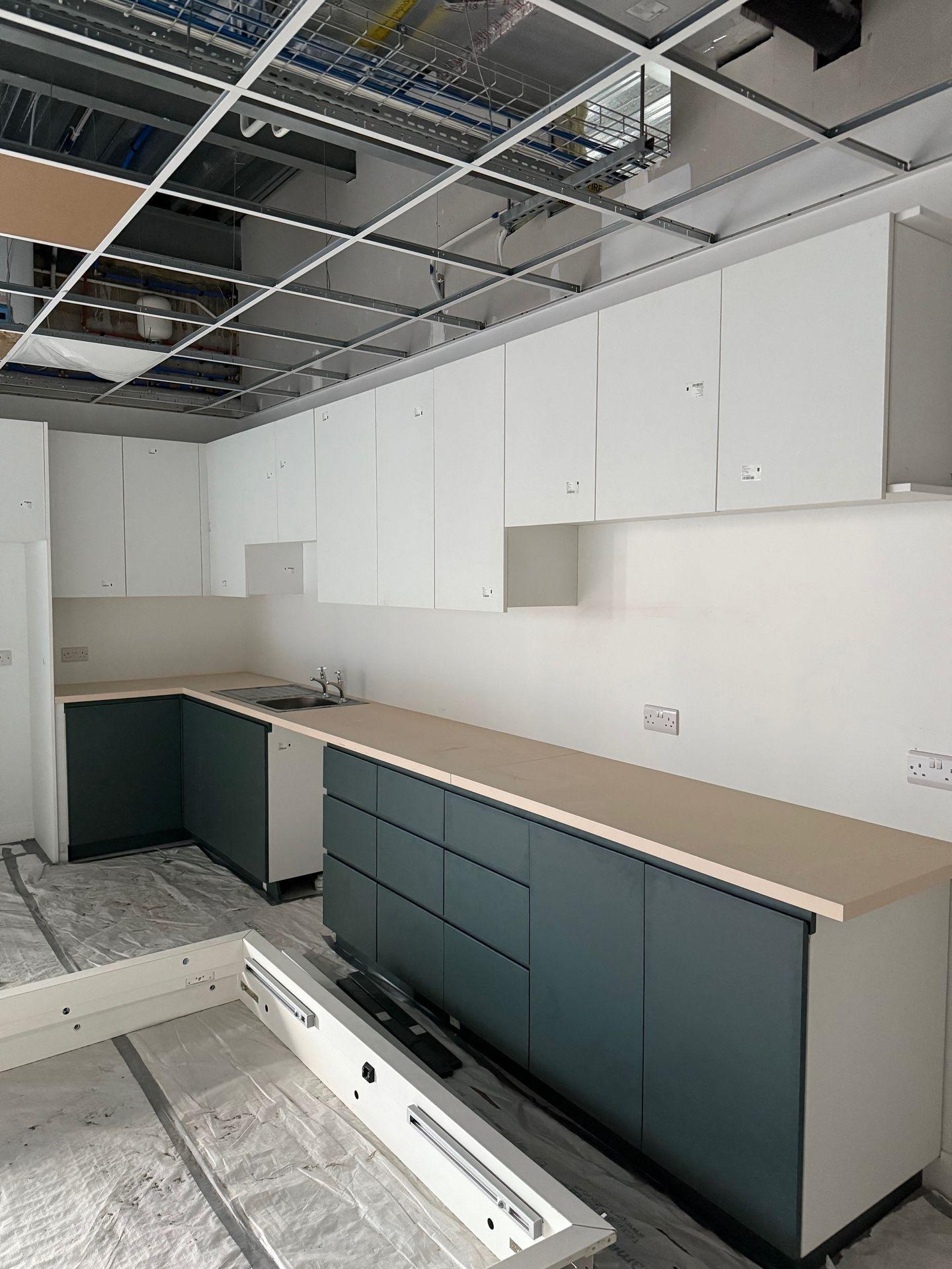 Contemporary kitchen with white and dark green cabinets