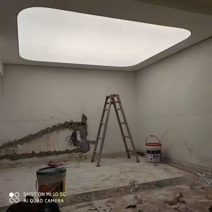 Stretch Ceilings - Modern Solutions for Customizable and Seamless Ceiling Designs Room under construction featuring a stretch ceiling with a smooth, illuminated panel and a ladder.